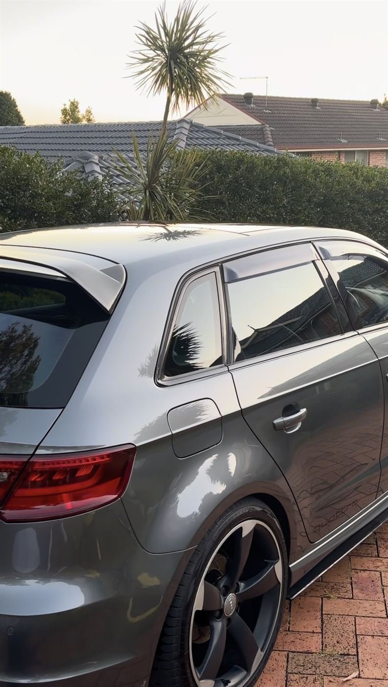Grey Audi hatch with a deep gloss finish at sunset